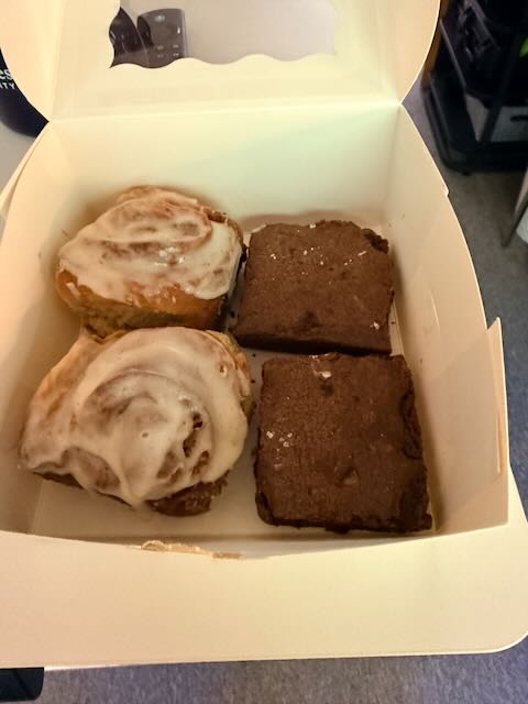 Cinnamon rolls and brownies in a bakery box